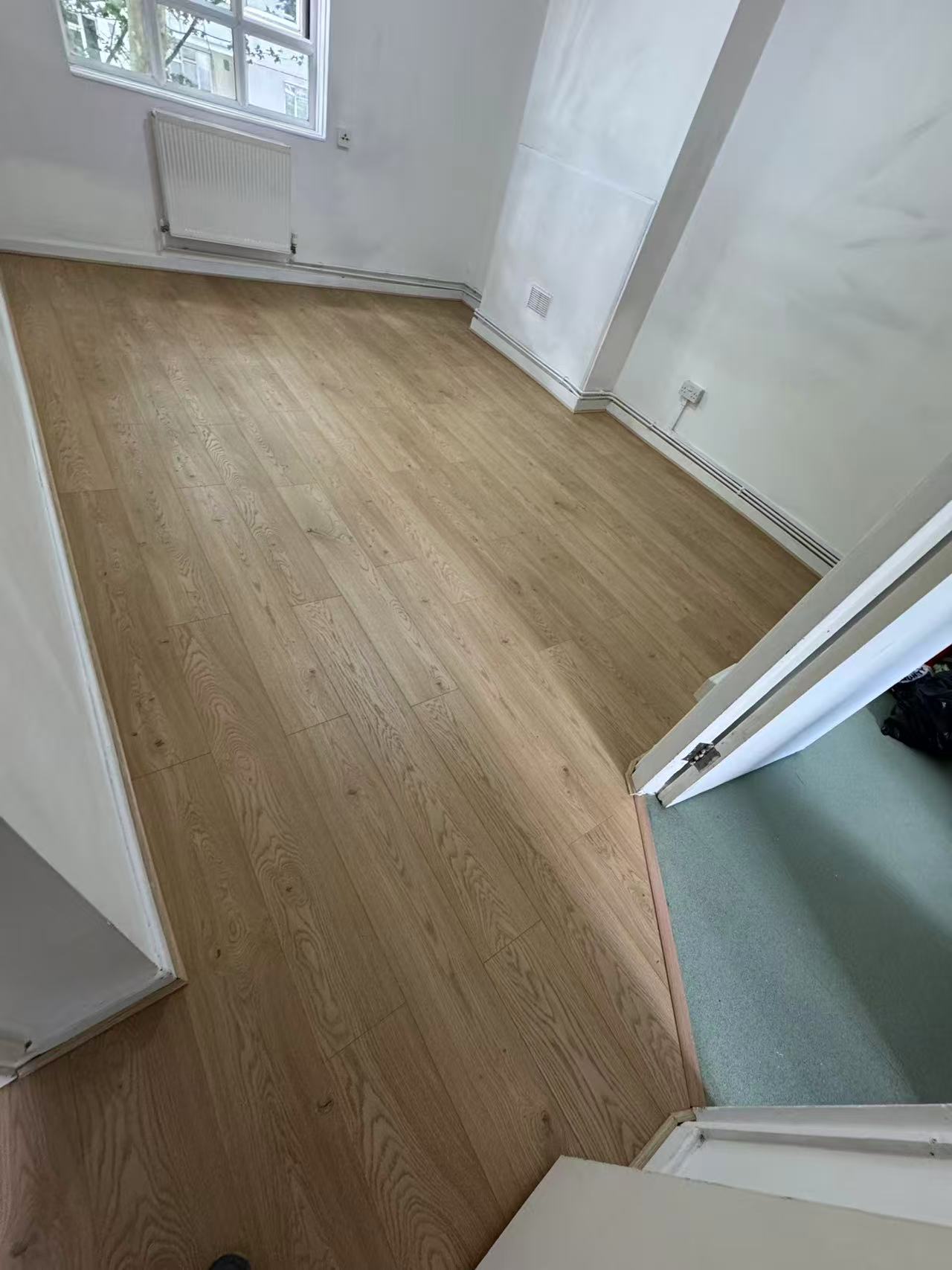 Hallway and reception laminate over a stripped concrete floor — image 1