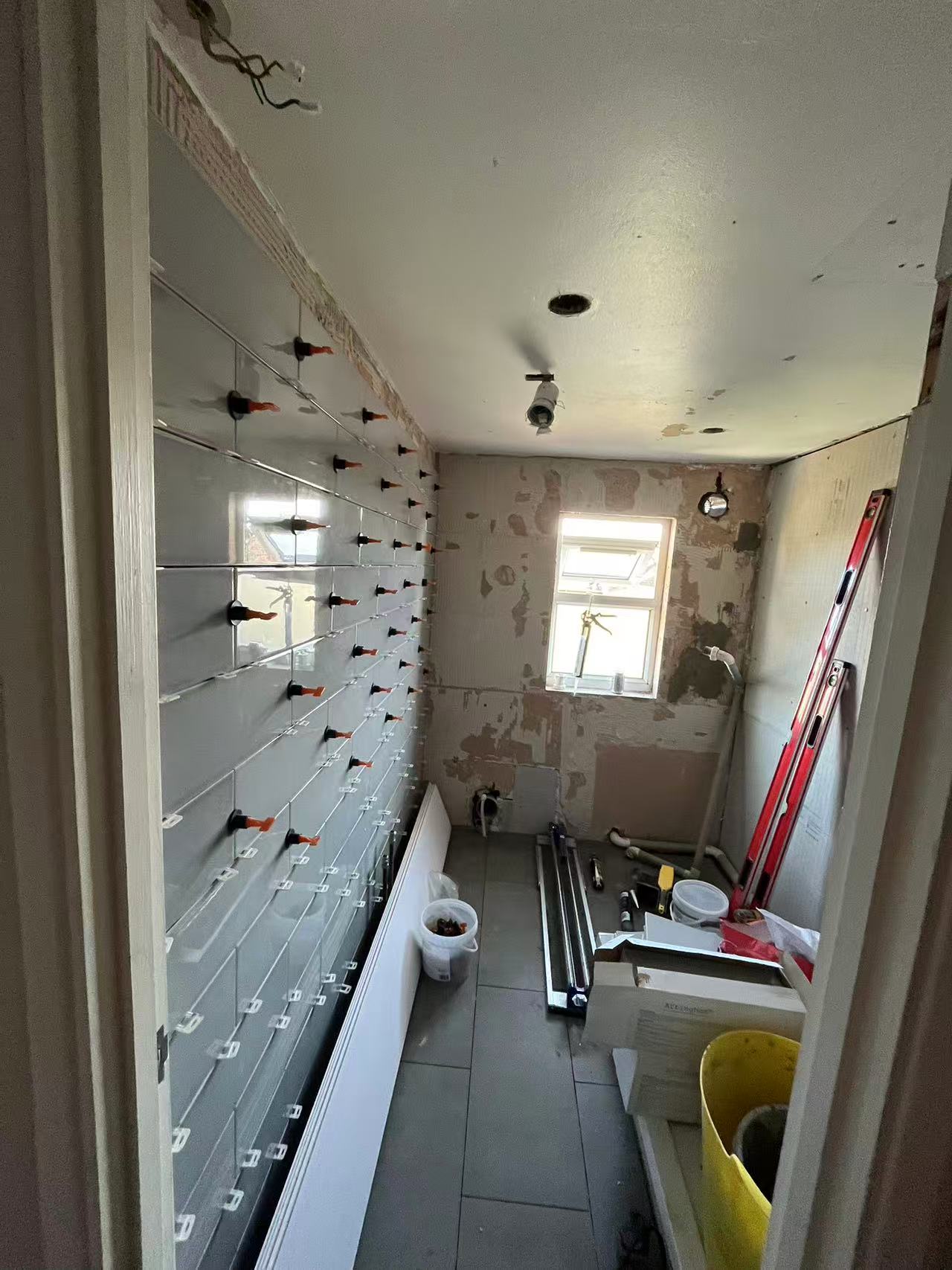 Full bathroom strip-out and retile in progress — image 1