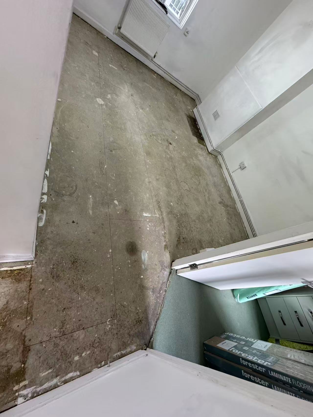 Hallway and reception laminate over a stripped concrete floor — image 4