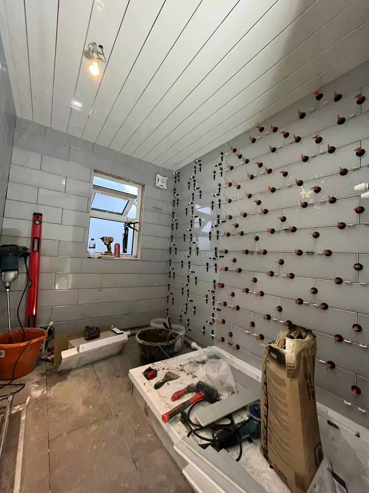 Full bathroom strip-out and retile in progress — image 5