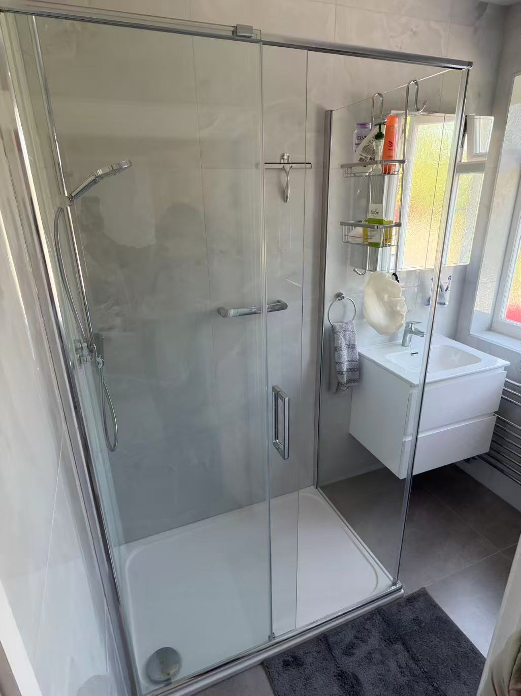 Marble-effect shower room with brushed gold fittings — image 2