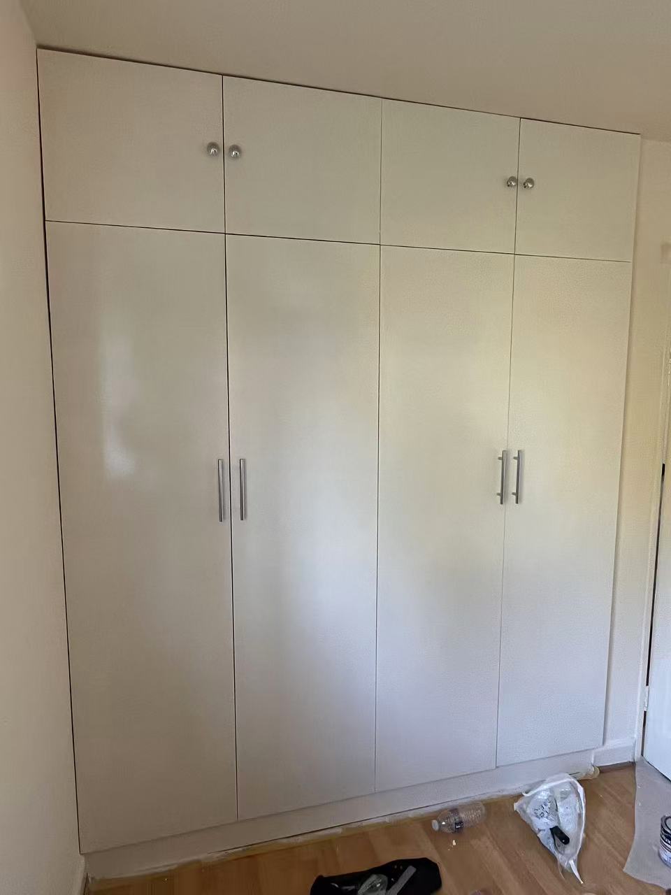 Painted fitted wardrobes with brushed steel handles — image 1