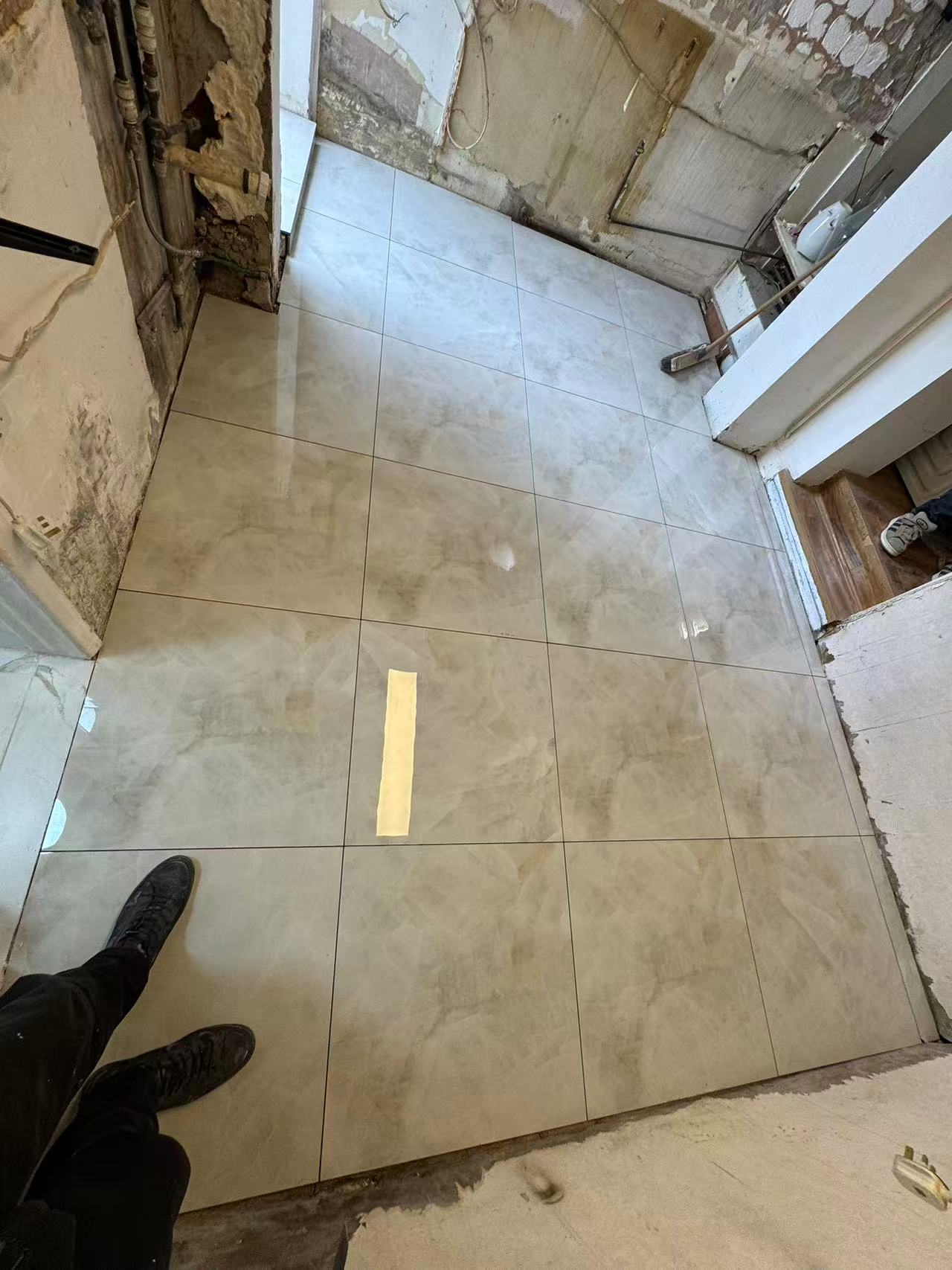 Hallway and ground floor porcelain tiling during full renovation — image 1